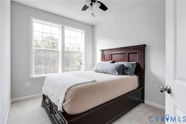 a bed sitting in a bedroom next to a window