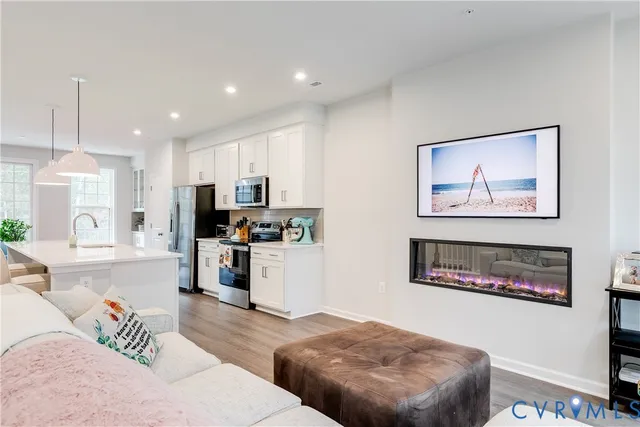 a living room with furniture and kitchen view