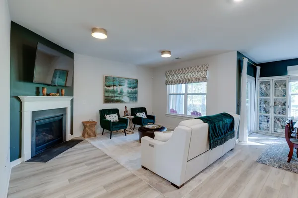 a living room with furniture and a fireplace