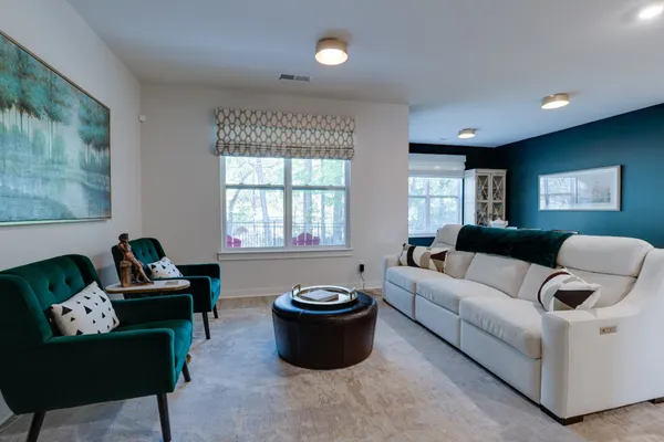 a dining room with furniture a rug and a floor to ceiling window