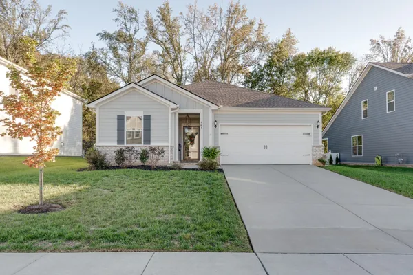 a view of a house with backyard and porch