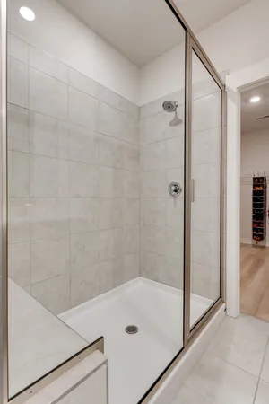 a view of an empty room with stairs and a window