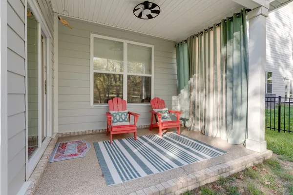 a view of a house with a yard porch and sitting area