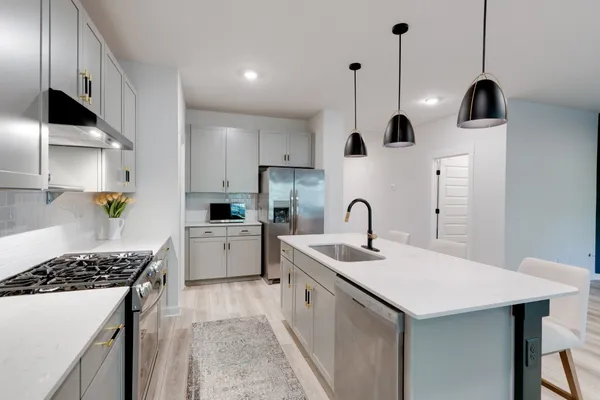 a large kitchen with stainless steel appliances kitchen island a large island in the center