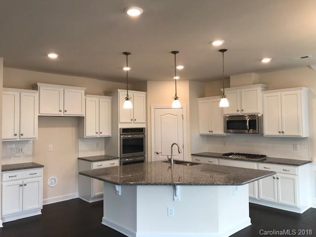 1573 Tranquility Boulevard, Unit 427 Lancaster, SC 29720 - Photo 2 of 12 a kitchen with stainless steel appliances granite countertop a sink a stove a refrigerator and white cabinets