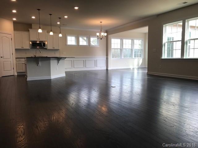 1573 Tranquility Boulevard, Unit 427 Lancaster, SC 29720 - Photo 3 of 12 an open kitchen with kitchen island and stainless steel appliances