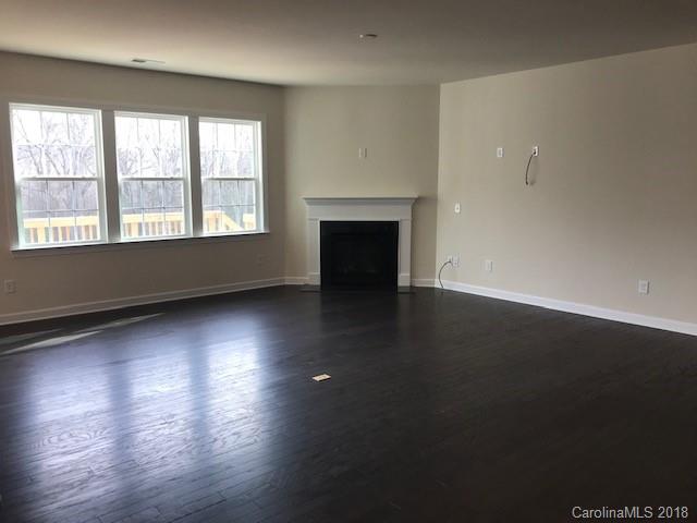 1573 Tranquility Boulevard, Unit 427 Lancaster, SC 29720 - Photo 4 of 12 an empty room with wooden floor and windows