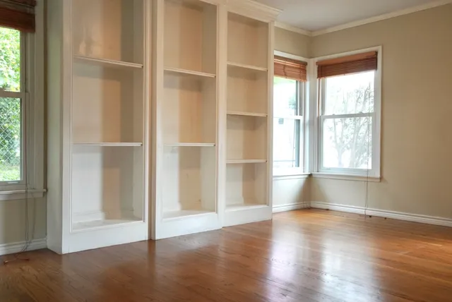 a view of a hallway with wooden floor