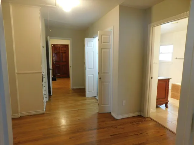 a kitchen with granite countertop white cabinets and black appliances