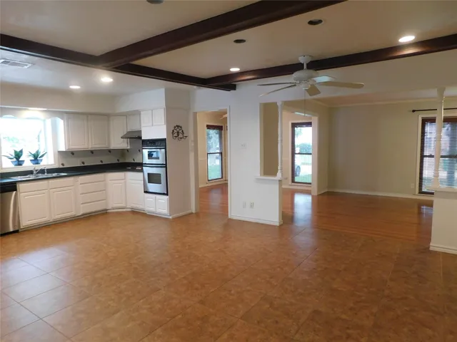 a bathroom with a granite countertop sink a shower and a mirror