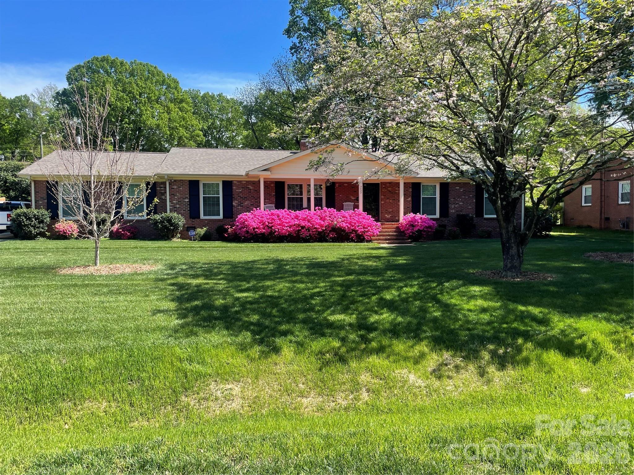 5022 Cheviot Road Charlotte, NC 28269 - Photo 2 of 4 a front view of a house with yard and green space