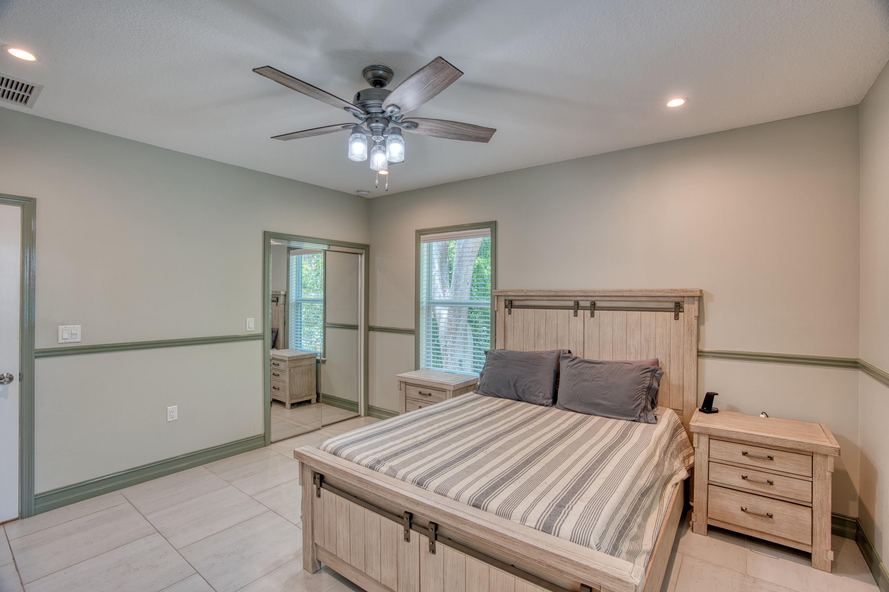 499 Beach Road Tavernier, FL 33070 - Photo 22 of 53 a bedroom with a bed and a chandelier