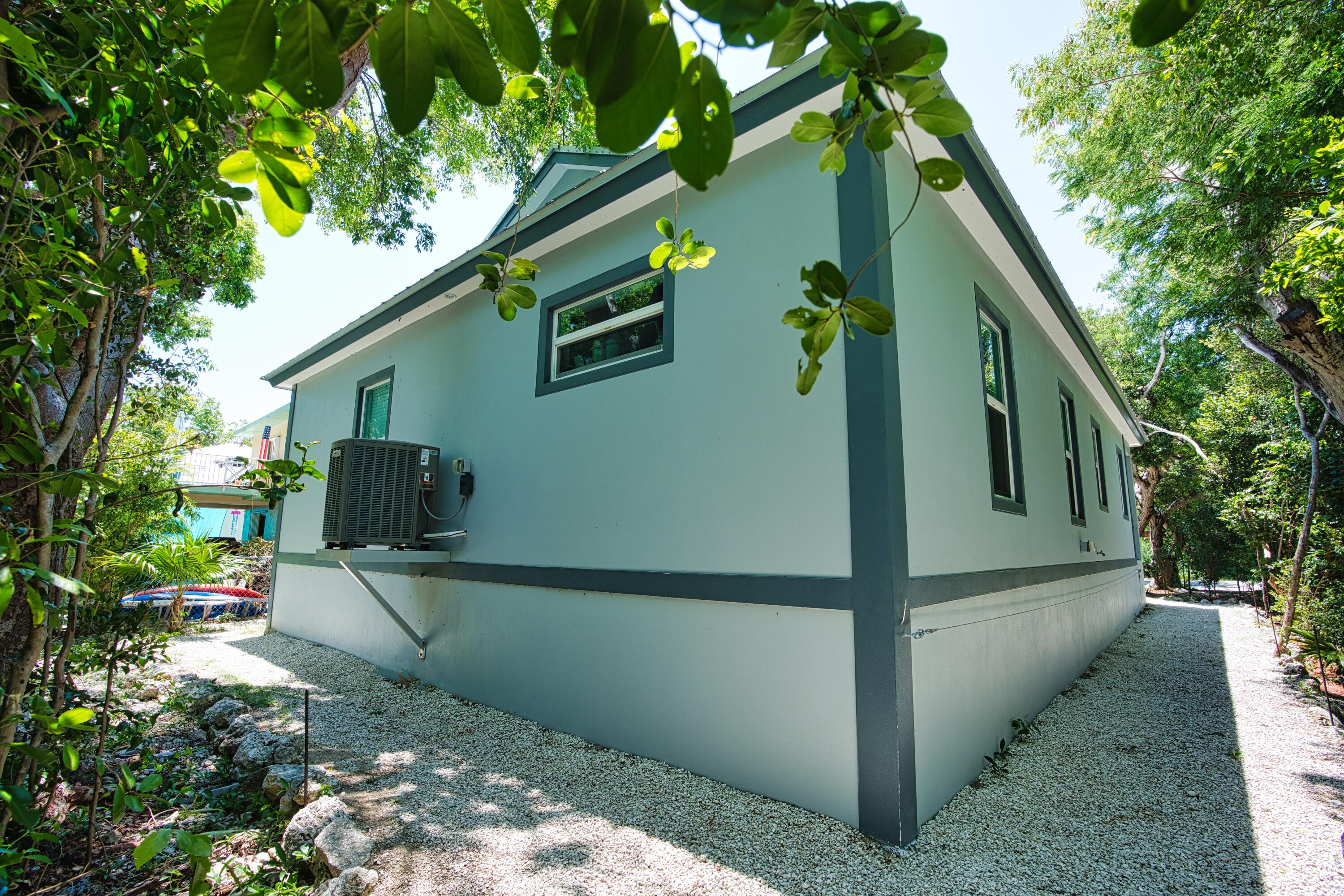 499 Beach Road Tavernier, FL 33070 - Photo 42 of 53 a backyard of a house with lots of green space