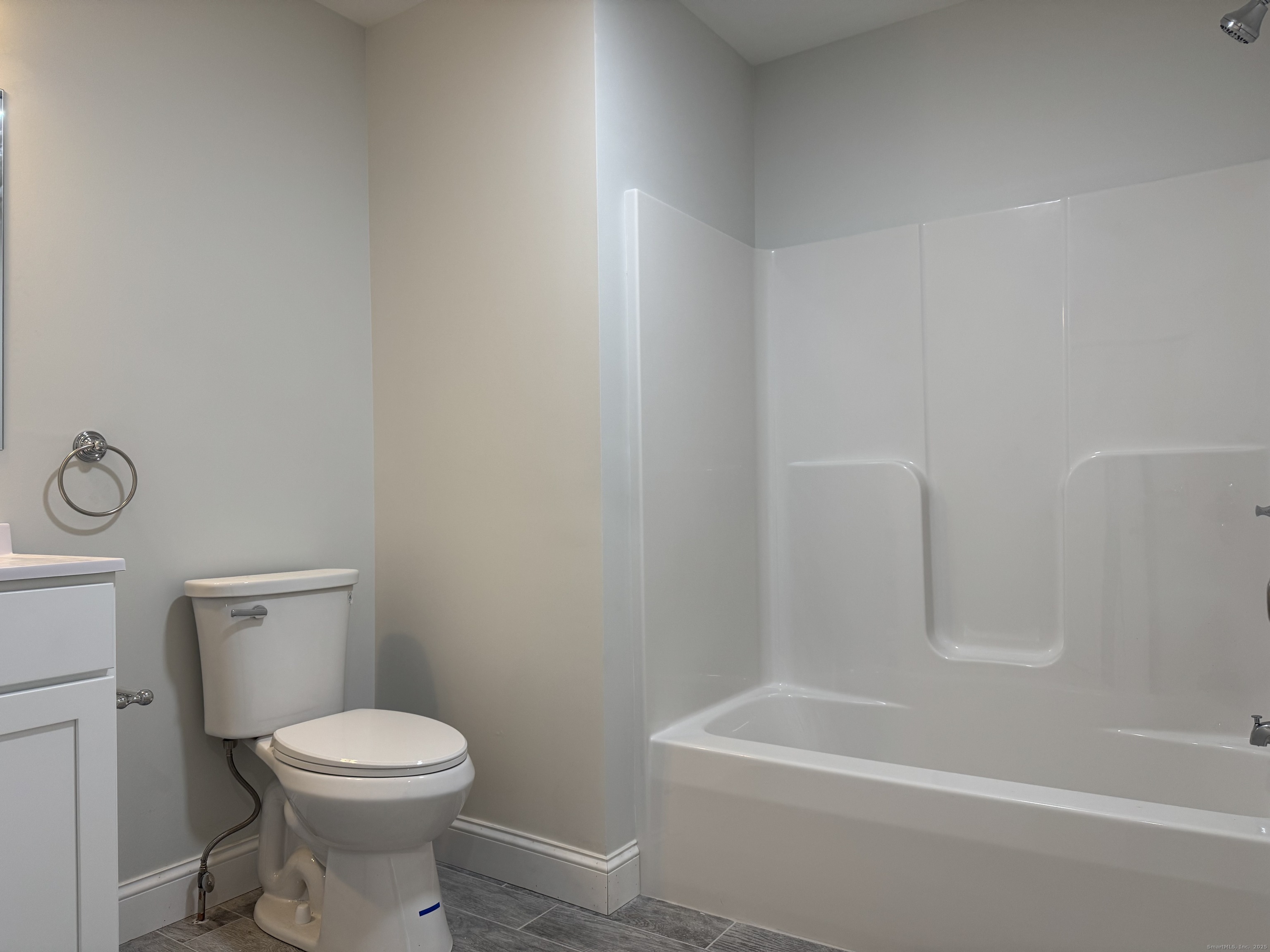 1085 Whalley Avenue, Unit 11 New Haven, CT 06515 - Photo 15 of 17 a white toilet sitting next to a bath tub