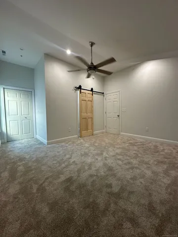 a view of a livingroom with a ceiling fan window and a ceiling fan
