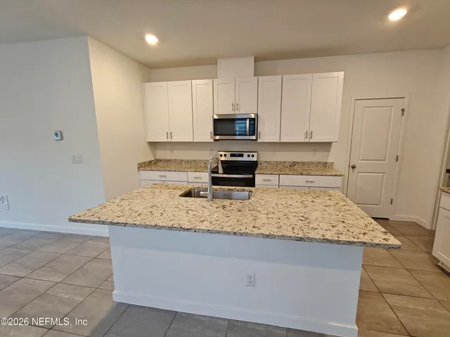 an empty room with closet and a ceiling fan