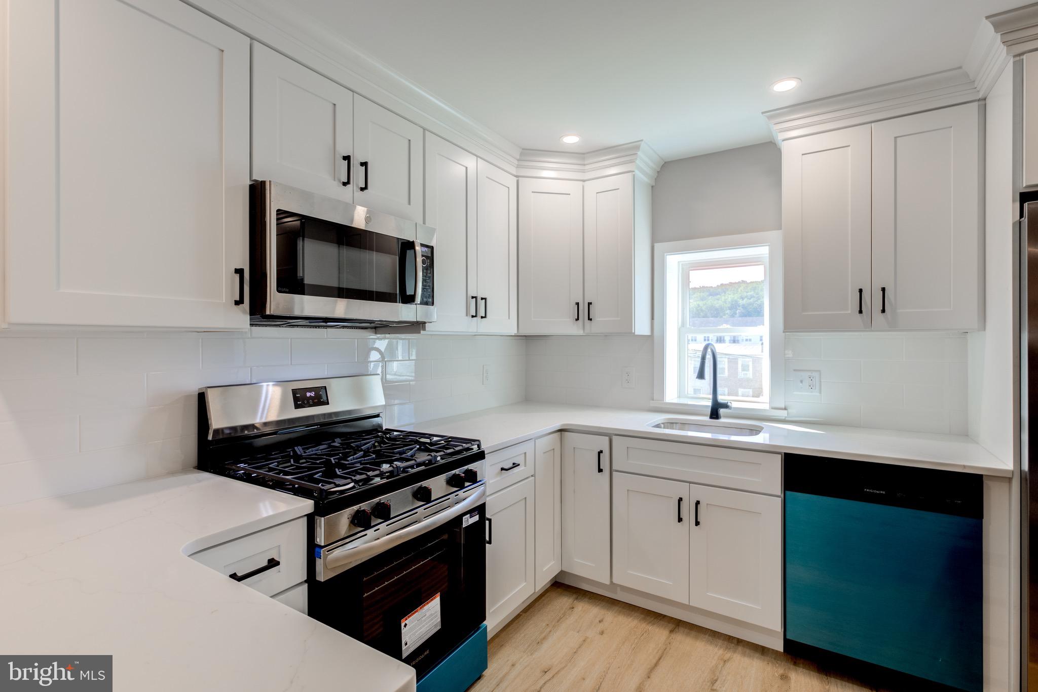 369 East Hector Street Conshohocken, PA 19428 - Photo 13 of 44 a kitchen with stainless steel appliances granite countertop white cabinets a sink dishwasher and a stove with wooden floor