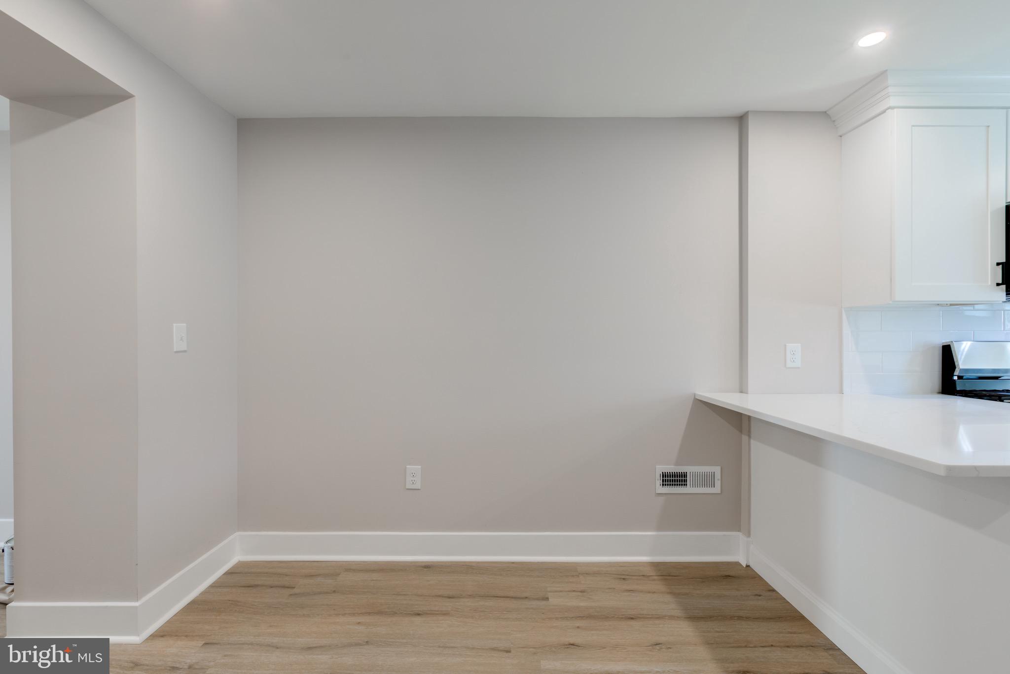 369 East Hector Street Conshohocken, PA 19428 - Photo 21 of 44 a view of a kitchen with white cabinets and wooden floor