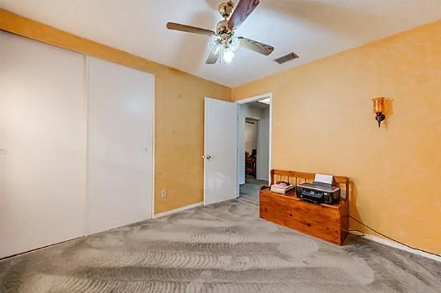 a room with closet and ceiling fan
