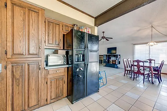 a kitchen with stainless steel appliances a refrigerator and dining table