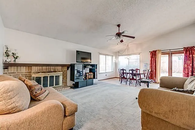 a living room with furniture fireplace and a flat screen tv