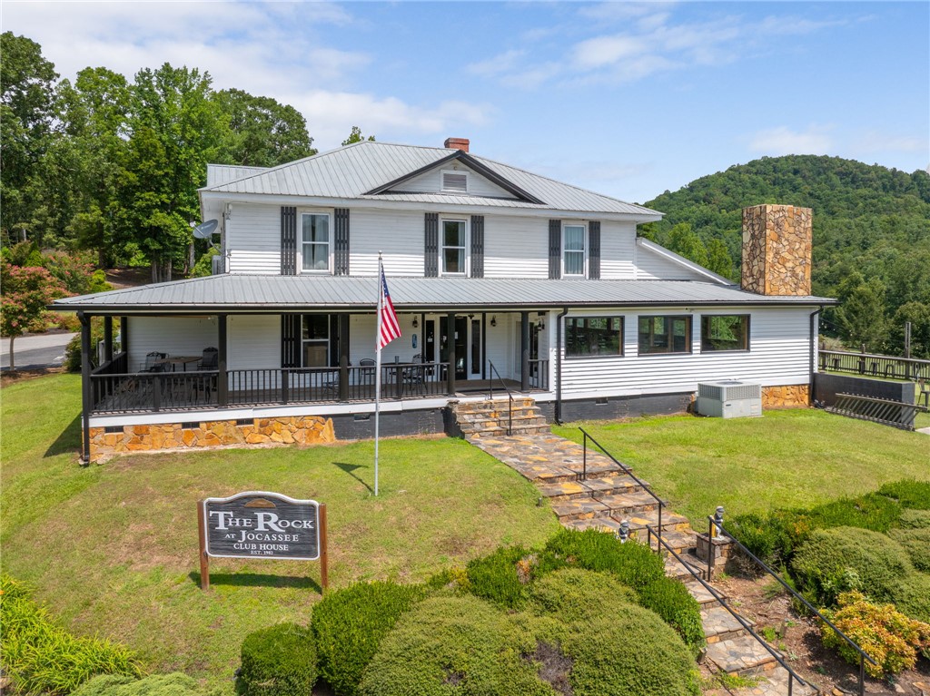300 Whispering Falls Road Pickens, SC 29671 - Photo 34 of 41 A classic two-story exterior showcases a wide covered front porch and a metal roof.