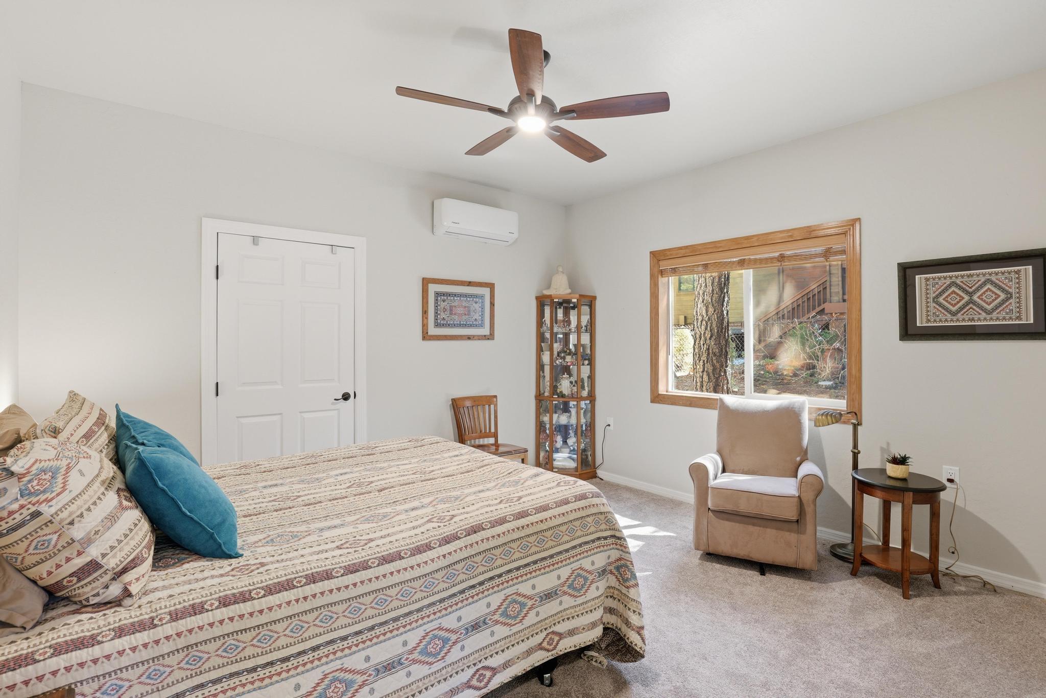 5501 Solitude Trail Loop Pine, AZ 85544 - Photo 19 of 27 a bedroom with a bed couches and window