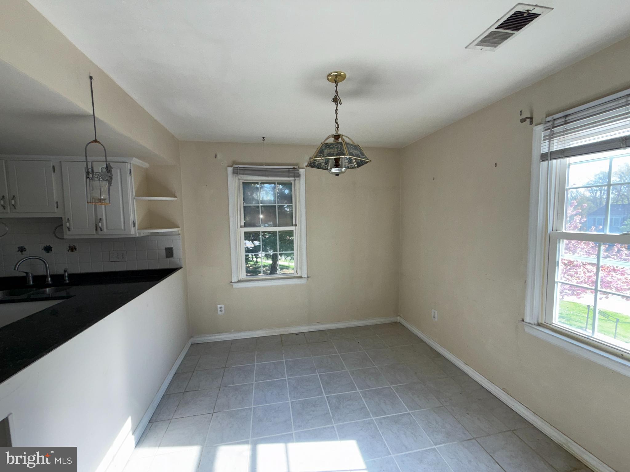 1050 Ramsgate Court Sterling, VA 20164 - Photo 9 of 20 a kitchen with granite countertop a stove a sink and a window