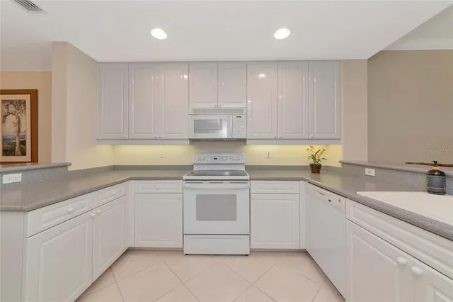 a kitchen with cabinets appliances and a sink