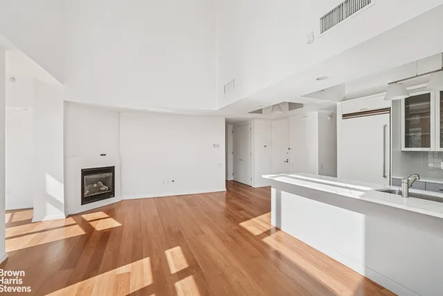 a view of a livingroom with furniture fireplace and wooden floor