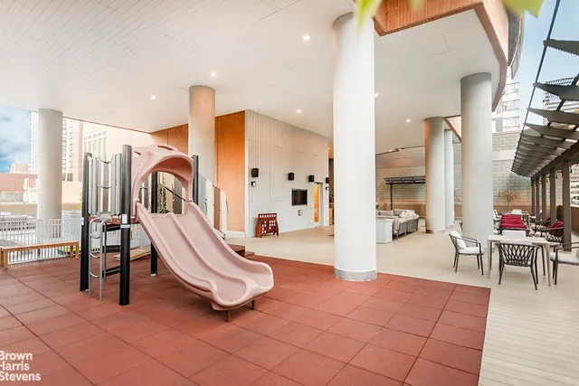 a living room with a large window and a rug