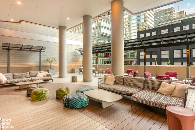 a view of a building with brick wall and plants