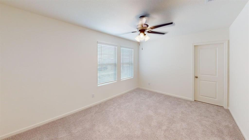 4529 Winecup Road Melissa, TX 75454 - Photo 15 of 29 Neutral-toned carpeting extends throughout this room, featuring two windows with horizontal blinds