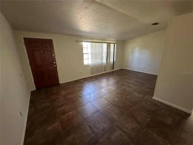 a view of an empty room and window in a room