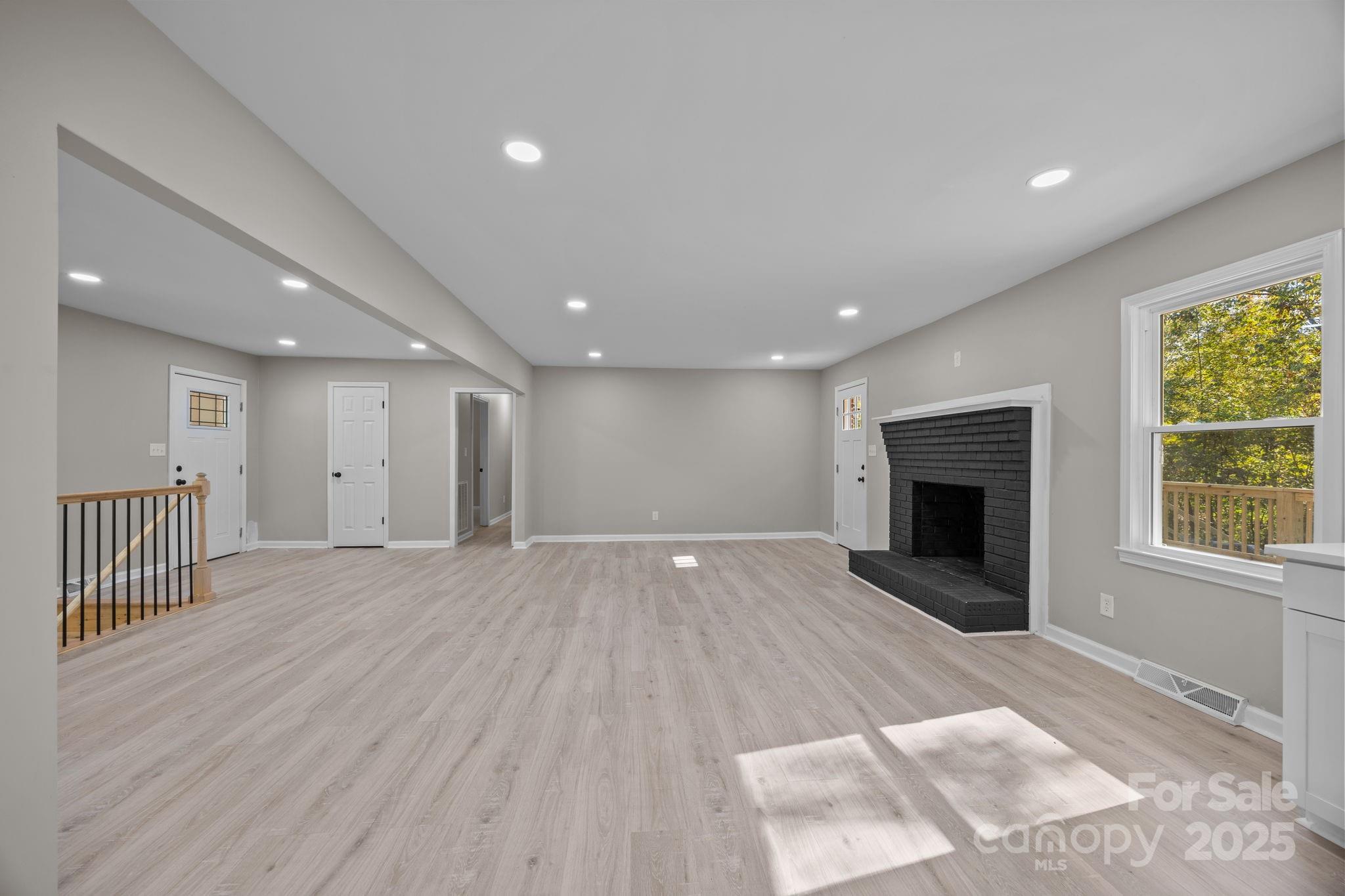 385 Pine Valley Road Salisbury, NC 28147 - Photo 20 of 35 an empty room with wooden floor and fireplace