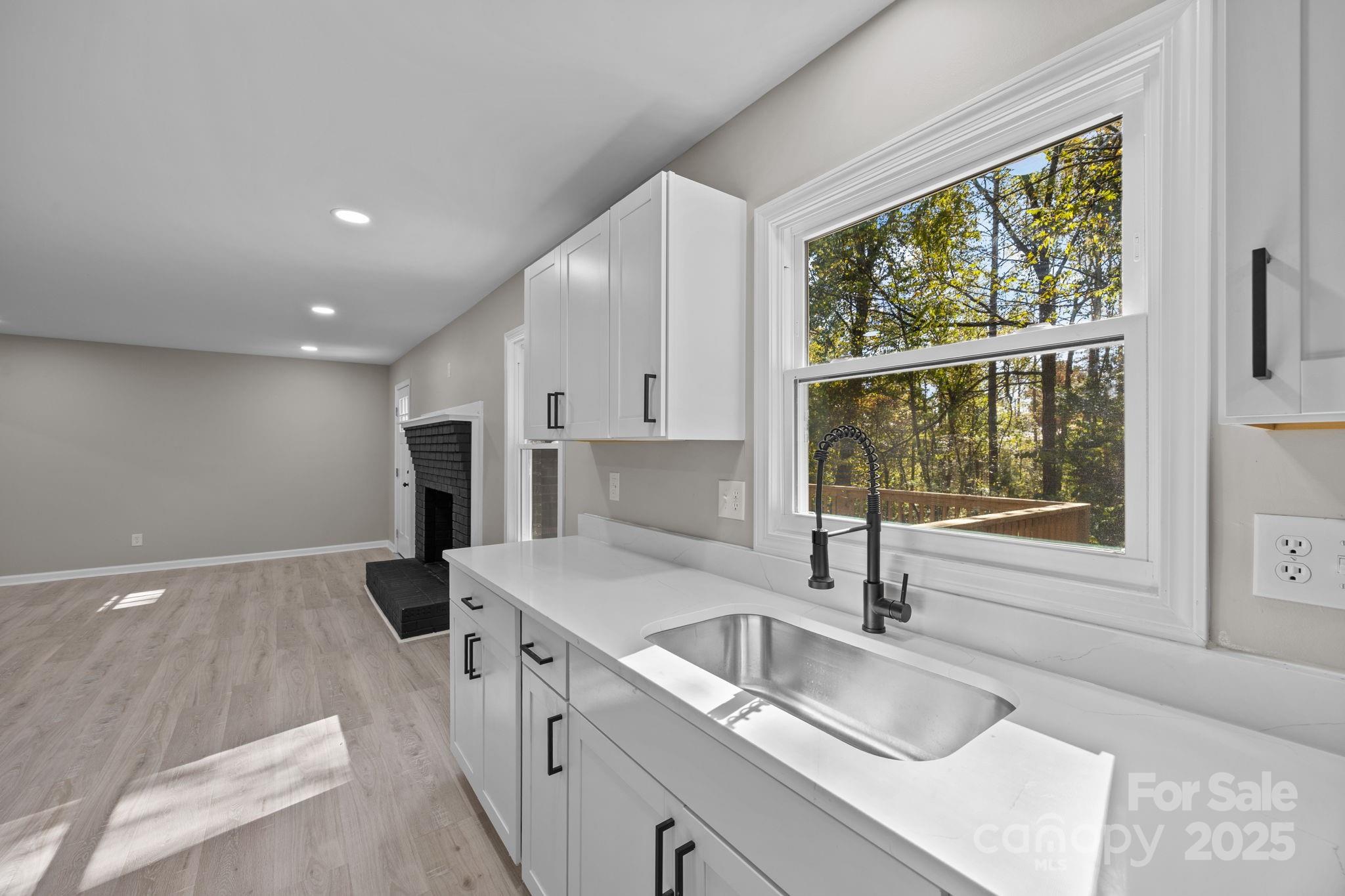 385 Pine Valley Road Salisbury, NC 28147 - Photo 23 of 35 a kitchen with granite countertop a sink and a refrigerator