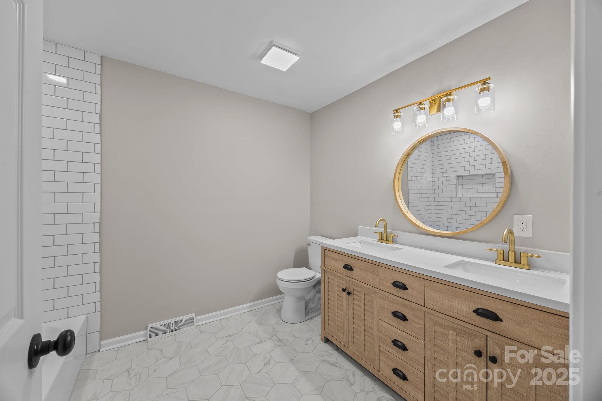 385 Pine Valley Road Salisbury, NC 28147 - Photo 26 of 35 a bathroom with a toilet a sink and mirror
