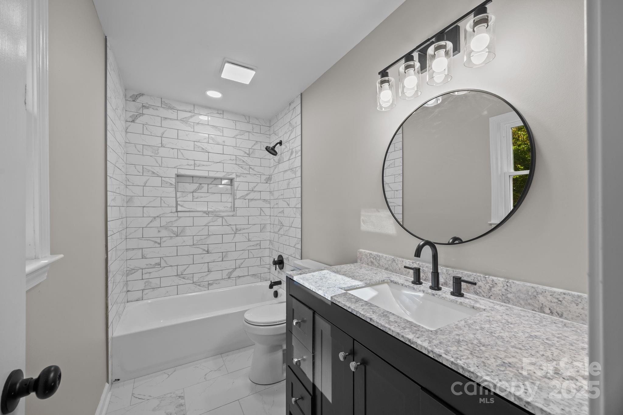 385 Pine Valley Road Salisbury, NC 28147 - Photo 30 of 35 a bathroom with a granite countertop toilet a sink and a mirror