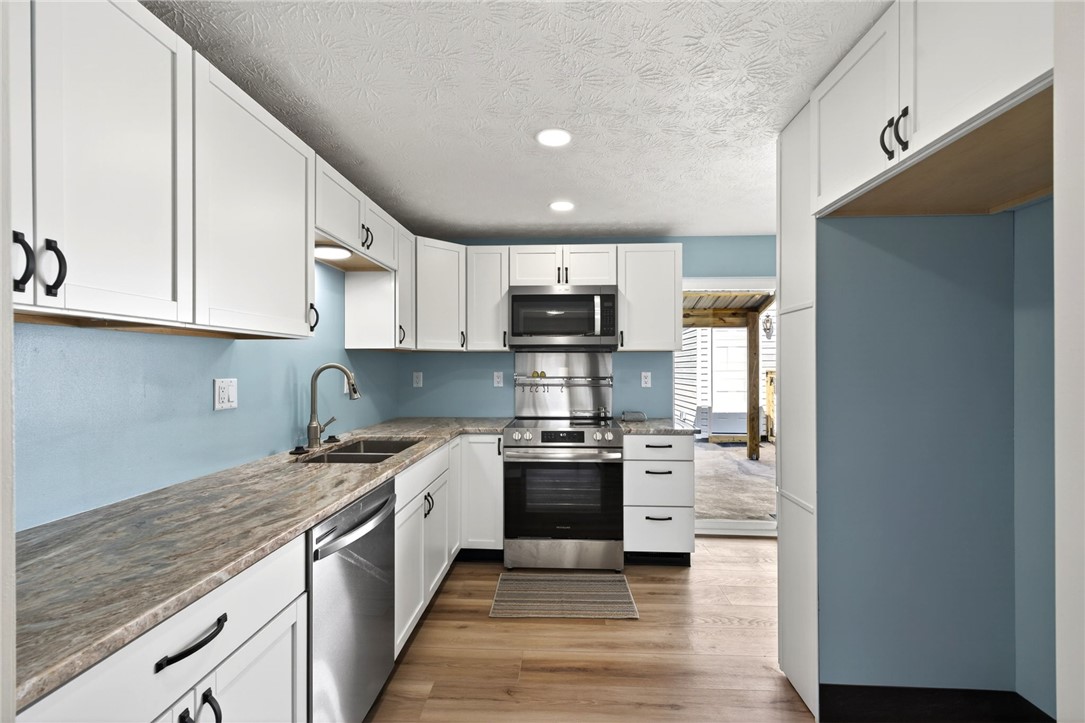 5975 Rosalie Road Dayton, OH 45424 - Photo 48 of 48 This newly renovated kitchen features sleek appliances and ample counter space, perfect for any home chef.