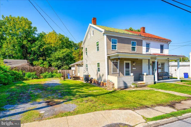 a front view of a house with a yard table and chairs