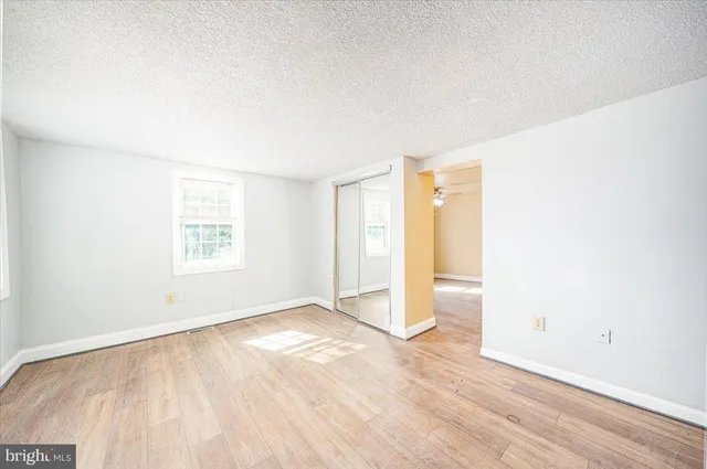 a living room with furniture and a mirror