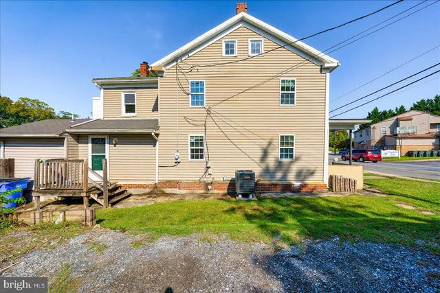 a backyard of a house with barbeque oven