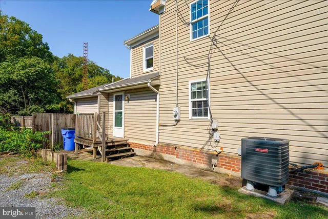 a backyard of a house with barbeque oven table and chairs