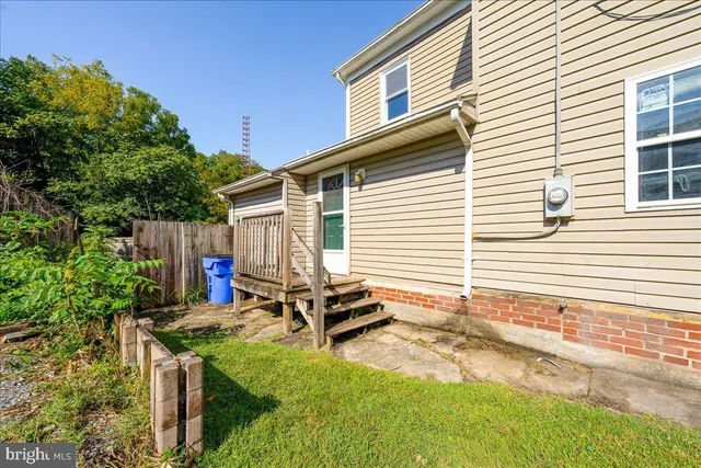 a view of a backyard with chairs and a patio