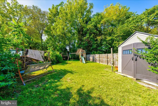 a view of a backyard with a slide and a child swing