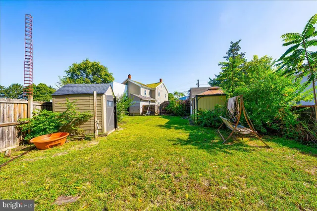 a front view of a house with yard and green space