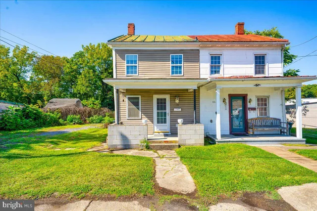 a view of a backyard with plants and a patio