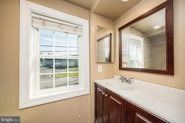 a bathroom with a sink and a window