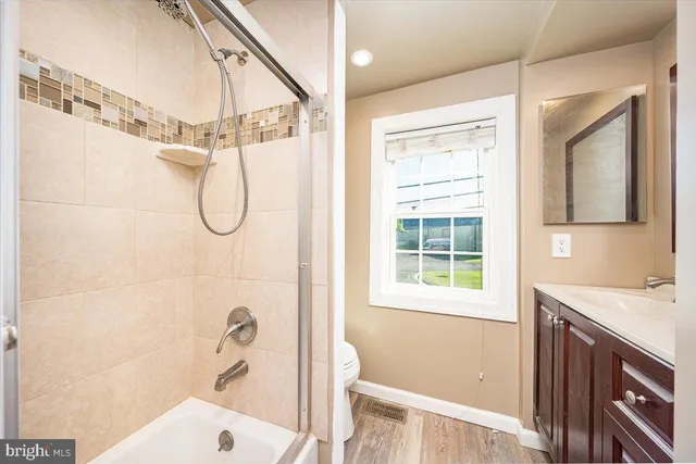 a bathroom with a sink a vanity and a shower