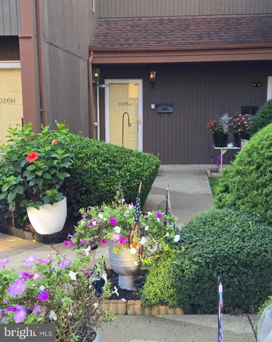 a front view of a house with a yard and flowers